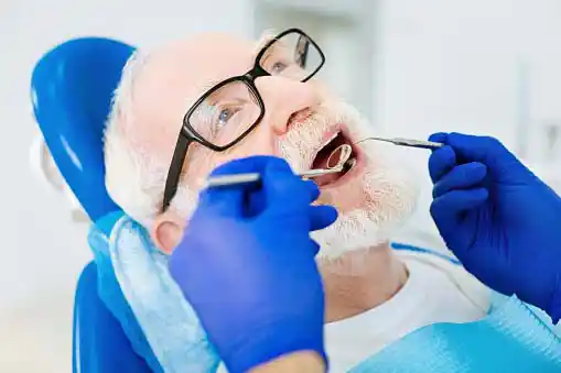 old man getting dental checkup=